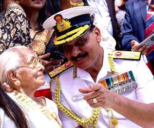 Admiral Dinesh Kumar Tripathi takes blessings of his mother Rajni Tripathi during a guard of honour ceremony before assuming charge as the 26th Navy chief