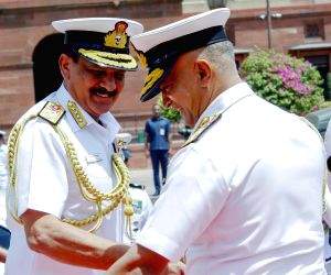Admiral Dinesh Kumar Tripathi with outgoing Navy Chief Adm R. Hari Kumar during a guard of honour ceremony before assuming charge as the 26th Navy chief